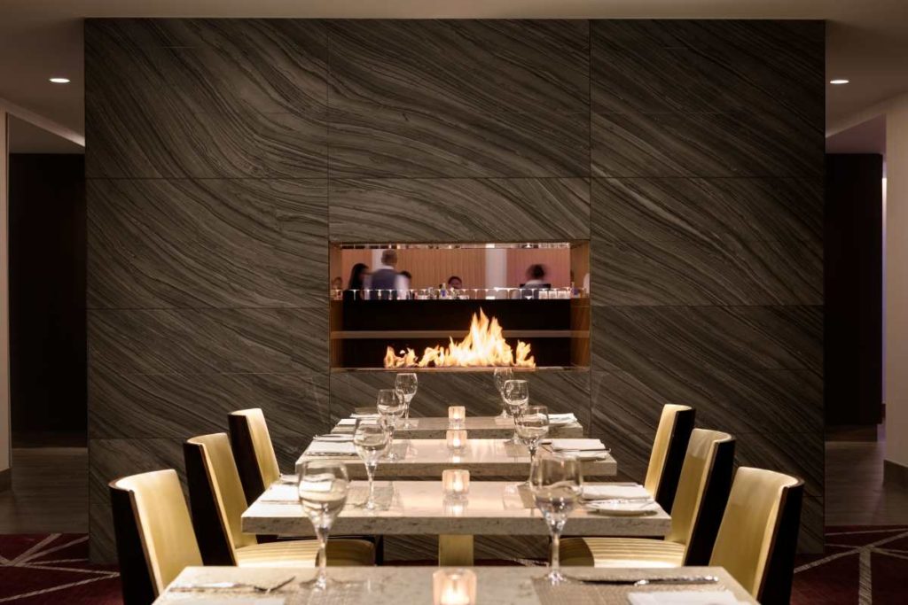 Communal Table located adjacent to the fireplace at L'Enfant Bar and Grill